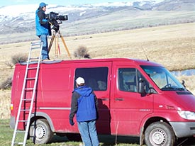 Sorensen on top of van. Jeff Laszlo on ground. "I climbed up on the top of my truck, and put the camera with the HJ40 on my lightweight sticks. The camera was buffeted by the wind and I was shivering so much I could hardly keep my eye to the eyepiece. When I switched on the HJ40’s stabilizer the image became rock steady. That shot would otherwise have been impossible to get under these conditions."